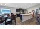Well-lit kitchen with black cabinets, stainless steel appliances, and a large island perfect for meal prep and entertaining at 394 Pentas Ln, Haines City, FL 33844