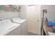 Bright laundry room with modern appliances and convenient shelving for organized storage at 394 Pentas Ln, Haines City, FL 33844