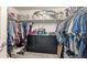 Organized walk-in closet featuring ample hanging space, shelving, and a central dresser for optimal storage solutions at 394 Pentas Ln, Haines City, FL 33844