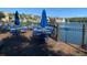 Outdoor deck overlooking a serene lake with seating, umbrellas, and community views at 4019 Venetian Bay Dr # 107, Kissimmee, FL 34741