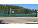An outdoor, fenced-in tennis court with a net, providing a great recreational opportunity at 4019 Venetian Bay Dr # 107, Kissimmee, FL 34741