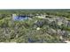Stunning aerial view showcasing property boundaries, mature trees, and proximity to a tranquil lake for added value at 42108 Pine Valley Dr, Paisley, FL 32767