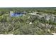 Scenic aerial view of the property, highlighting its lush surroundings and location near the water offering peaceful retreat at 42108 Pine Valley Dr, Paisley, FL 32767
