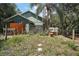 Backyard featuring a wooden fence, palm tree, and tropical plants at 42108 Pine Valley Dr, Paisley, FL 32767