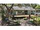 Spacious backyard with mature trees providing shade and privacy and a deck for outdoor entertaining at 42108 Pine Valley Dr, Paisley, FL 32767
