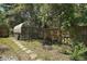 Greenhouse in a backyard garden for cultivating plants year-round, enclosed by a wooden fence at 42108 Pine Valley Dr, Paisley, FL 32767