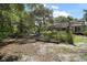 Expansive backyard featuring a garden, mature trees, and ample space for outdoor activities at 42108 Pine Valley Dr, Paisley, FL 32767