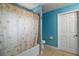 Bathroom with a shower featuring a themed curtain, plus blue walls and tiled floor at 42108 Pine Valley Dr, Paisley, FL 32767