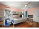 Comfortable bedroom with a bunk bed and natural light, showcasing wood floors at 42108 Pine Valley Dr, Paisley, FL 32767