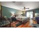 Spacious bedroom featuring wood floors, ceiling fan, and a large sliding door at 42108 Pine Valley Dr, Paisley, FL 32767