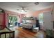 Bright bedroom with a bunk bed, wood floors, and access to the backyard at 42108 Pine Valley Dr, Paisley, FL 32767