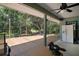 Covered back deck offering ample space with views of the lush greenery of the backyard at 42108 Pine Valley Dr, Paisley, FL 32767