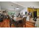 Open-concept dining area with wood floors, seamlessly connecting living space at 42108 Pine Valley Dr, Paisley, FL 32767