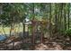 Backyard duck coop next to a pond, set within a wooded landscape at 42108 Pine Valley Dr, Paisley, FL 32767