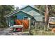 A view of the side of a charming home with a wooden fence and lush foliage at 42108 Pine Valley Dr, Paisley, FL 32767