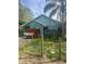 Charming home with green exterior paint, surrounded by lush foliage and greenery at 42108 Pine Valley Dr, Paisley, FL 32767