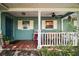 Covered front porch with red tile, and comfortable seating at 42108 Pine Valley Dr, Paisley, FL 32767