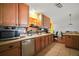 Modern kitchen featuring lots of storage space in light brown cabinetry with stainless appliances at 42108 Pine Valley Dr, Paisley, FL 32767