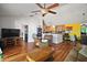 Inviting living room with wood floors open to the kitchen, dining area and front entry at 42108 Pine Valley Dr, Paisley, FL 32767