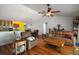 Cozy living room featuring hardwood floors, neutral walls, and stylish furnishings with easy access to the kitchen and dining area at 42108 Pine Valley Dr, Paisley, FL 32767