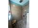 Modern tiled shower featuring multiple shower heads and a built in bench at 42108 Pine Valley Dr, Paisley, FL 32767