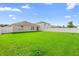 Spacious backyard featuring green grass and a full white vinyl fence at 4529 Orchard Grove Rd, St Cloud, FL 34772