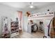 Bright bedroom featuring a loft bed with a built-in desk and shelves at 4529 Orchard Grove Rd, St Cloud, FL 34772