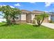 Charming single-story home featuring lush green lawn and desert landscaping at 4529 Orchard Grove Rd, St Cloud, FL 34772