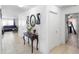 Bright hallway with tile flooring leading to a living room with leather furniture at 4529 Orchard Grove Rd, St Cloud, FL 34772