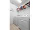 Laundry room with a washer, a dryer, and a wire shelf for storage at 4529 Orchard Grove Rd, St Cloud, FL 34772