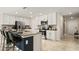 Modern kitchen featuring white cabinets, stainless steel appliances, and a large center island with seating at 4693 Golden Knight Blvd, Kissimmee, FL 34746