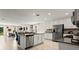 Open-concept kitchen with stainless steel appliances and island seating overlooks the living area at 4693 Golden Knight Blvd, Kissimmee, FL 34746
