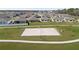Aerial view of a community sand volleyball court surrounded by green space and benches at 4694 Golden Knight Blvd, Kissimmee, FL 34746