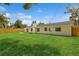 Spacious backyard featuring a well-kept lawn, wooden privacy fence, and a concrete patio at 5021 Saint Marie Ave, Belle Isle, FL 32812