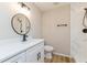 Modern bathroom featuring a sleek vanity, round mirror, and a shower with marble-like tile at 5021 Saint Marie Ave, Belle Isle, FL 32812