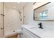 Bathroom featuring modern fixtures, including a sleek vanity and a shower with marble-like tile at 5021 Saint Marie Ave, Belle Isle, FL 32812