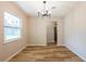 Charming dining room with a modern light fixture and wood-look flooring at 5021 Saint Marie Ave, Belle Isle, FL 32812
