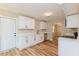 Modern kitchen featuring white cabinetry, quartz countertops, stainless steel appliances, and hardwood floors at 5021 Saint Marie Ave, Belle Isle, FL 32812