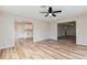 Bright and open living room featuring hardwood floors, neutral walls, and a ceiling fan at 5021 Saint Marie Ave, Belle Isle, FL 32812
