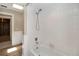 Bathroom featuring tub shower, skylight, and white tile at 5057 Maui Cir # 15, Orlando, FL 32808