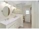 Bright bathroom features a double sink vanity and glass block accent wall at 5057 Maui Cir # 15, Orlando, FL 32808