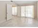 Bright bedroom with double doors leading to a screened-in patio area at 5057 Maui Cir # 15, Orlando, FL 32808
