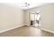Neutral bedroom with wood floor and sliding doors out to patio at 5057 Maui Cir # 15, Orlando, FL 32808