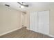 Neutral bedroom with wood floor and large closet at 5057 Maui Cir # 15, Orlando, FL 32808
