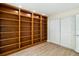 Bedroom featuring wood floor and built in shelves, with closet for storage at 5057 Maui Cir # 15, Orlando, FL 32808
