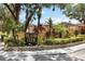 The Island Club community sign surrounded by lush greenery on a sunny day at 5057 Maui Cir # 15, Orlando, FL 32808