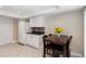 Cozy dining area near the kitchen featuring bright lighting, neutral paint, and a dark wood dining set at 5057 Maui Cir # 15, Orlando, FL 32808
