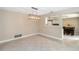 Cozy dining space featuring tile floors, neutral paint and modern lighting, with a peek into the kitchen area at 5057 Maui Cir # 15, Orlando, FL 32808