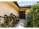 Inviting front entrance adorned with lush greenery, featuring a security screen door and warm, welcoming ambiance at 5057 Maui Cir # 15, Orlando, FL 32808
