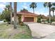 Charming home exterior with a red tile roof, attached garage, and lush landscaping at 5057 Maui Cir # 15, Orlando, FL 32808